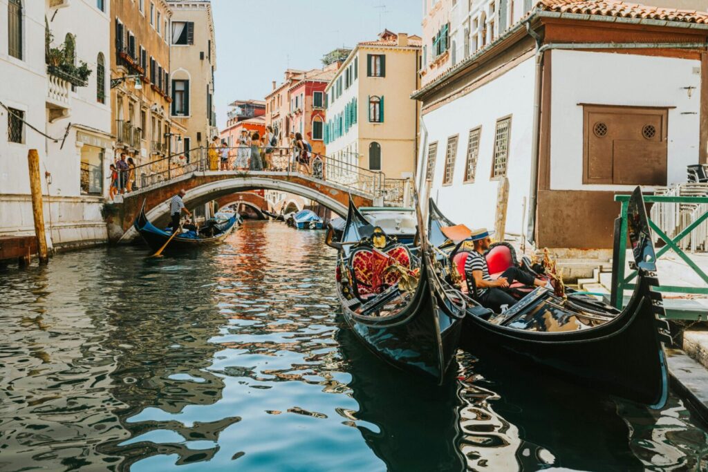 A picturesque scene of gondolas navigating a historic canal in Venice, Italy.