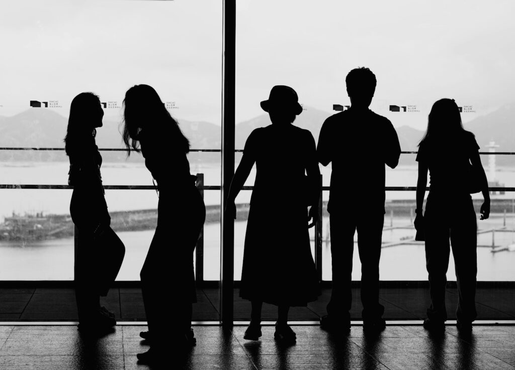 a group of people standing in front of a window